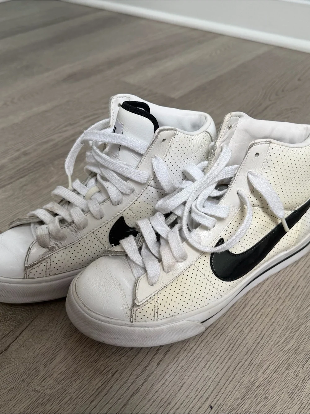 Nike Women's White High-Top Sneakers with Black Swoosh